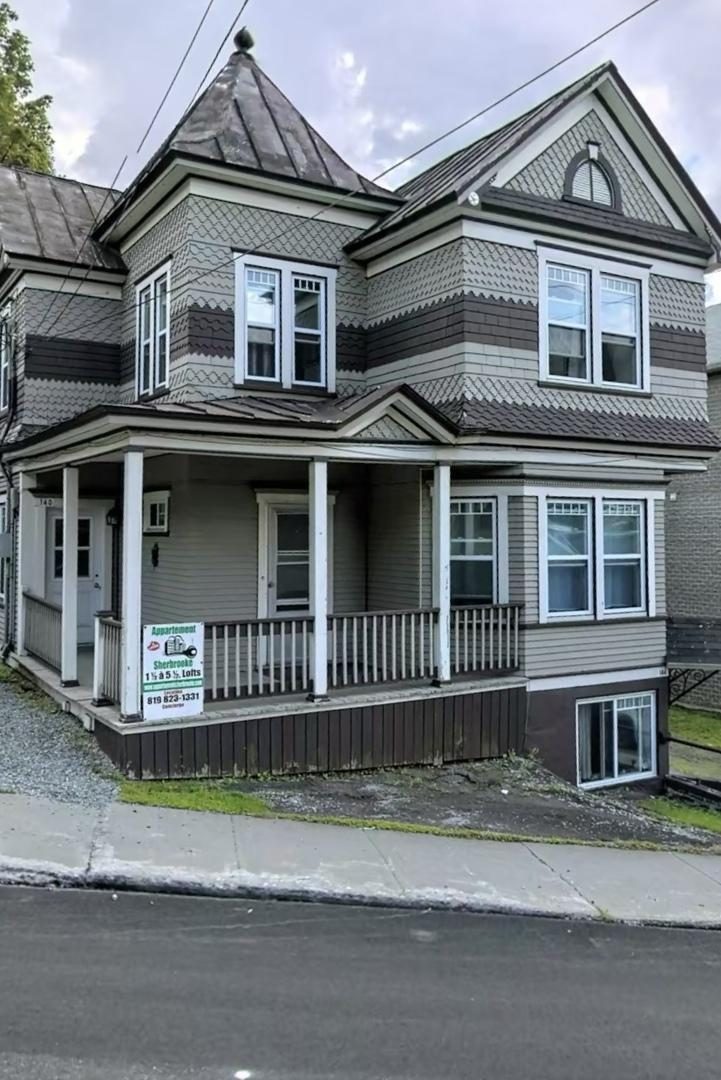 Victorian building at 142 Conseil in Sherbrooke with a turret, porch and rental sign